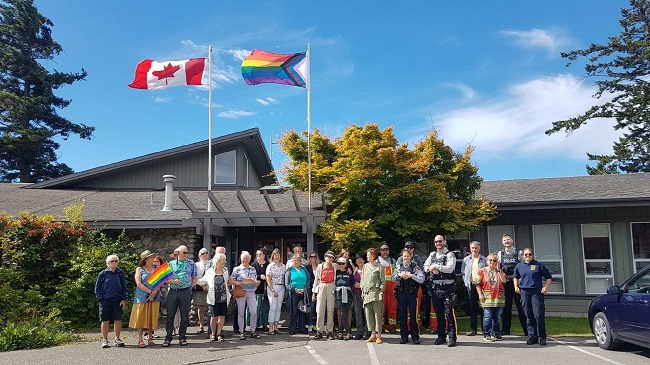 West Shore RCMP and Metchosin Council raise Pride flag over Municipal Hall