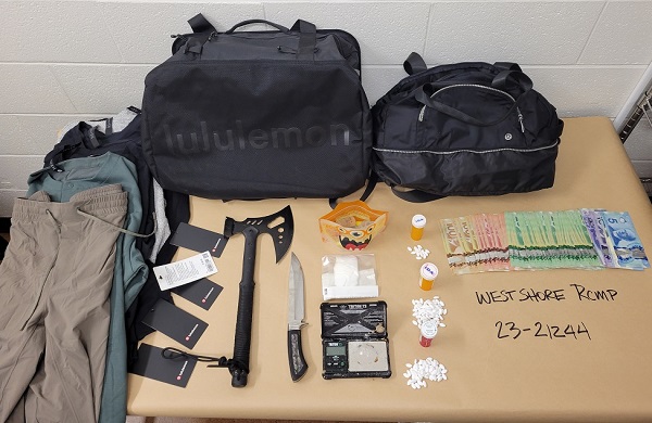 Photo of stolen clothing, drugs, cash and weapons located by police