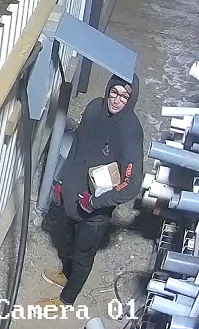 suspect male wearing dark framed glasses, a black hoodie and dark touque, black pants, brown shoes, red gloves and is clean shaven